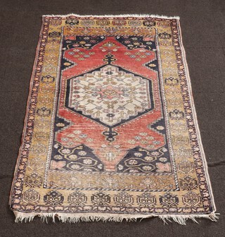 A red, blue and white Turkish rug with diamond shaped central medallion 192cm x 103cm 