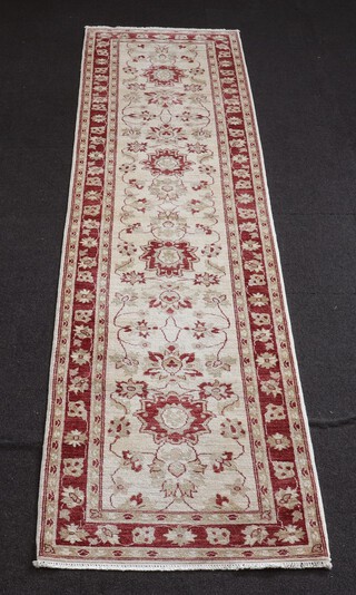 A white and red ground Ziegler style runner with multi row borders, 341cm l x 81cm w 