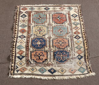 A blue, tan and white ground Caucasian style rug with 8 stylised medallions to the centre 166cm x 113m 