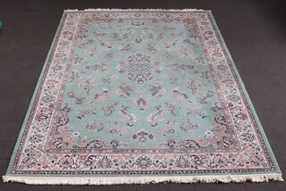 A green, white and floral patterned machine made Persian style carpet with central medallion 344cm x 241cm 