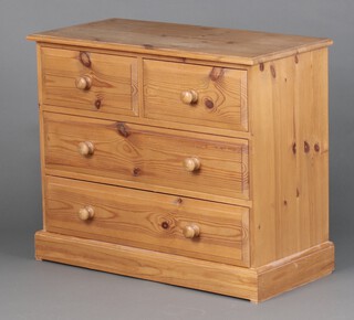 A pine chest of 2 short and 2 long drawers with turned handles, on a platform base 75cm h x 90cm w x 43cm d 