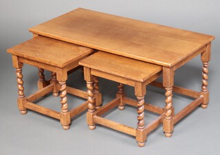 A rectangular light oak nest of 3 coffee tables on spiral turned supports 45cm h x 100cm w x 48cm d (water and contact marks in places) 