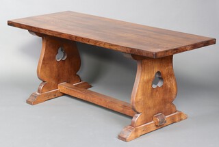 A rectangular elm refectory dining table, the top formed from 3 planks, raised on standard end supports with H framed stretcher 79cm h x 182cm l x 77cm w 