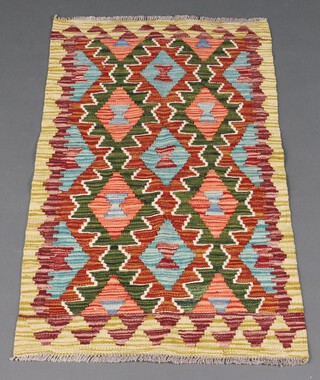 An orange, green and tan ground Chobi Kilim runner 196cm x 60cm 
