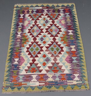 A white, green and tan ground Chobi Kilim rug with overall geometric design 124cm x 85cm 