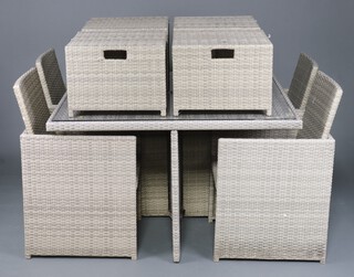 A Bramblecrest rattan style garden suite comprising square table 75cm h x 124cm, 4 chairs, 4 stools and a garden umbrella, together with various seat cushions  (the table is missing one foot) 
