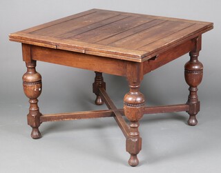 An oak drawleaf dining table with cup and cover supports and X framed stretcher, 77cm h x 102cm l x 98cm w 