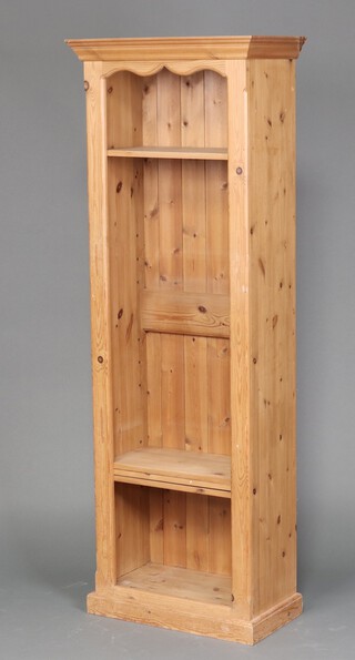 A pine bookcase with moulded cornice, fitted adjustable shelves 183cm h x 65cm w x 35cm d 