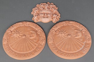Two circular terracotta wall sundials (dial missing) 45cm together with a terracotta mask in the form of Bacchus 35cm 