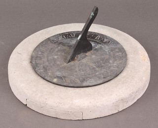 A circular engraved metal sundial on a concrete base 30cm h 