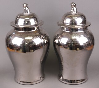 A large pair of Chinese style silvered pottery urns and covers of baluster form with dragon finials 53cm h 
