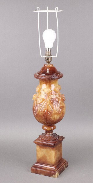 A carved hardstone table lamp in the form of a stylised pineapple raised on a square base 53cm h 