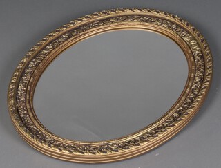 A rectangular plate mirror contained in a gilt plaster frame 71cm x 58cm 