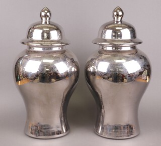 A large and impressive pair of silver coloured pottery lidded urns 54cm h 