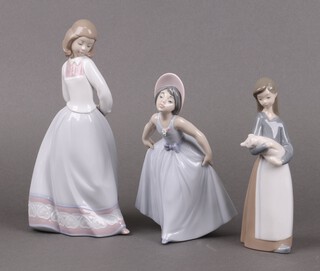 Three Lladro figures - Sweet and Shy 6754, Daisy 6274 and Girl with Pig 1011 