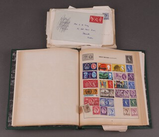 A collection of 1960's World Stamps in a small album together with a collection of miscellaneous stamps contained within envelopes