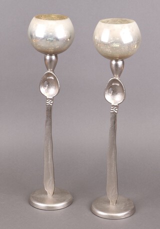 A pair of silvered resin tea light holders in the form of spoons 50cm 