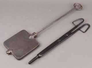 A 19th Century waffle iron/ biscuit press together with a pair of 19th Century iron tongs 
