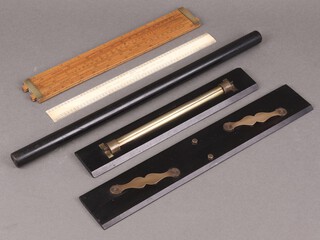 A boxwood slide rule, a parallel ruler and an Army & Navy rolling ruler and other geometry instruments 