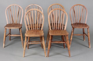 A set of 6 beech and elm hoop back dining chairs 