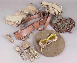 A leather Sam Brown belt, a pair of webbing gaiters, beret and a small collection of camouflage netting 