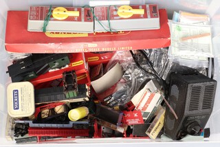 A power supply unit 492/240 and a collection of O gauge rolling stock and rails, contained in a clear plastic box 