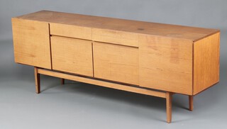 A mid-century teak sideboard fitted 2 drawers above cocktail unit, flanked by cupboards enclosed by panelled doors, on square supports 74cm h x 188cm w  x 36cm d  (water and contact marks in places) 