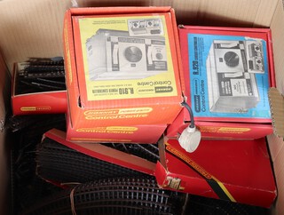 A large collection of railway track together with 3 Hornby control centres - R920, R10 and RP920, boxed, contained in a cardboard box 