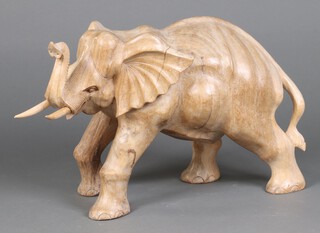 An African carved bleached hardwood figure of an elephant 36cm h  x 60cm l