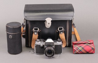A Praktica PL noval SLR camera with hard case, telephoto lens, 35 mm lens and other accessories 