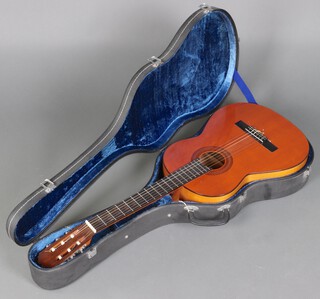 A "Malaga" Spanish 6 string acoustic guitar contained in a plush lined black hardcase  
