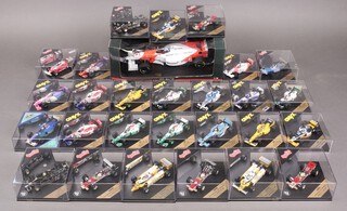 A collection of Onyx and Quartzo scale model cars of Formula One cars  (27), together with a Paul's Model Art 1:18 scale model of a McLaren Mercedes Formula One racing car 