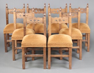 A set of 8 oak framed dining chairs with upholstered seats 