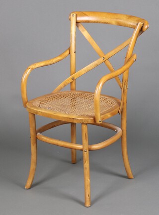 A Thonet style bentwood open arm chair with woven rush seat 