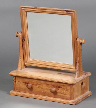 A rectangular plate mirror contained in a pine swing frame, the base fitted a drawer 51cm h x 43cm w x 21cm d