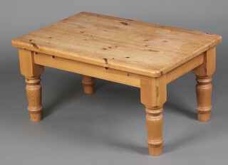 A rectangular pine coffee table, raised on turned supports 46cm h x 90cm w  