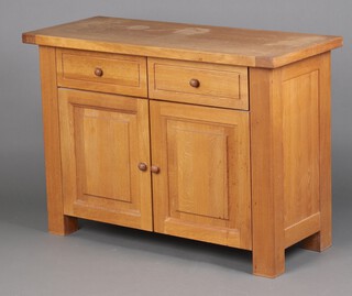 An oak dresser base fitted 2 drawers above double cupboard 85cm h x 120cm w x 50cm d (water and contact marks in places)