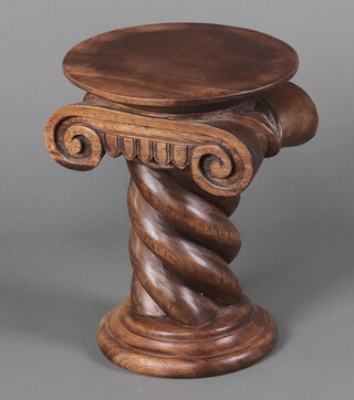 A hardwood pedestal in the form of an Ionic capital on a spiral turned column 50cm h x 39cm diam. 