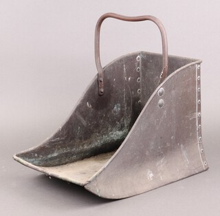 A copper coal scuttle with swing handle 