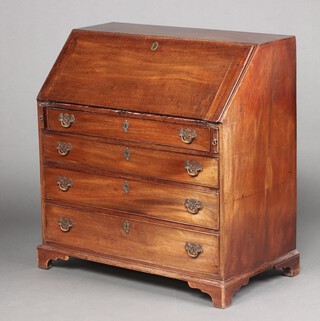 A Georgian mahogany bureau, the fall front revealing a well fitted interior with drawers and pigeon holes above 4 drawers with replacement drop handles, raised on bracket feet 103cm h x 97cm w x 53cm d  