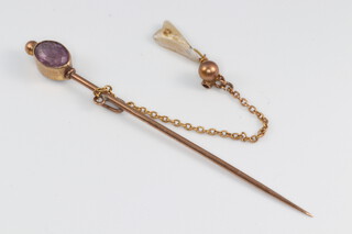 A 9ct gold stick pin set an amethyst and with safety chain, 1.5g
