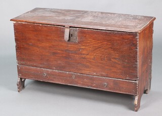 An early 18th century elm boarded chest with drawer/mule chest, the front board and drawer having chipped edges, the front board fitted a square lock plate, the drawer with round escutcheon and ring drop handles, the drawer with runners but only supported by base rails, the interior back board with section of replacement timber and strap hinges, evidence of grooves for candle box  68cm h x 113cm w x 41cm d 