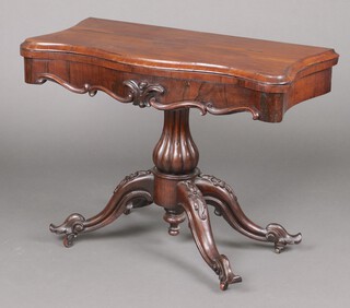 A Victorian rosewood card table of serpentine outline, raised on a turned column and tripod base 67cm h x 90cm w x 43cm d 