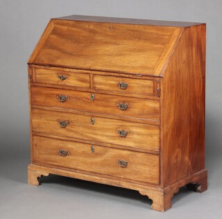 A Georgian mahogany bureau, the fall front revealing a well fitted interior with drawers and pigeon holes, above 2 short and 3 long drawers with brass escutcheons and replacement handles, raised on bracket feet 111cm h x 106cm x 53cm d 
