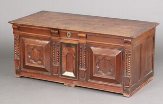 An 18th century oak coffer with hinged lid and panels to the front, raised on a later pine base (made up) 57cm h x 130cm w x 62cm d 