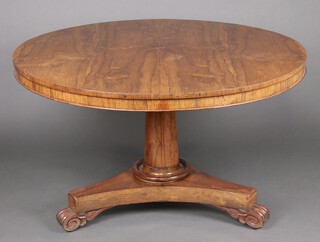 A Regency circular rosewood snap top breakfast table on a turned column with triform base ending in spade feet 75cm h x 103cm diam. 