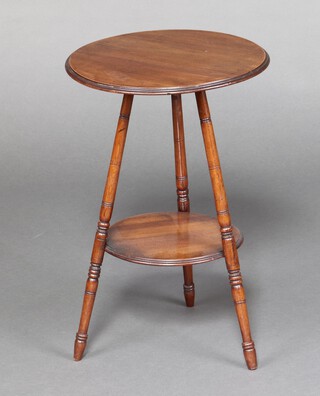 An Edwardian circular walnut 2 tier occasional table raised turned and outswept supports 57cm h x 37cm diam. 