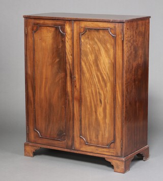 A 19th century mahogany cabinet with shelved interior enclosed by panelled doors, raised on bracket feet 116cm h x 91cm w x 43cm d 