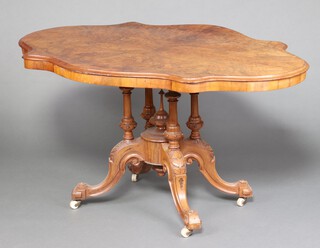 A Victorian figured walnut and quarter veneered Loo table of serpentine outline, raised on 4 turned columns and tripod base 77cm h x 142cm w x 106 cm d 