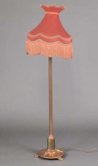 An Art Nouveau copper and brass standard lamp raised on a circular foot with sprawled feet 111cm h 